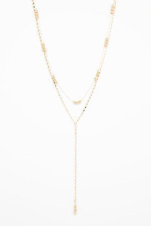 Gold necklace with two chains and beads
