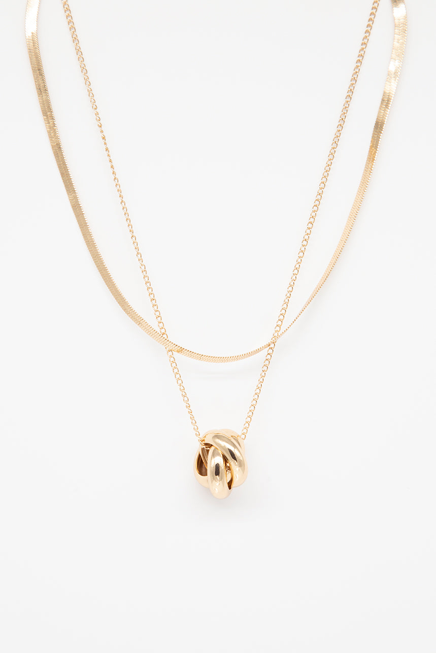 Double gold chain and twisted medallion