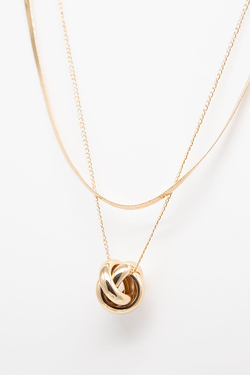 Double gold chain and twisted medallion